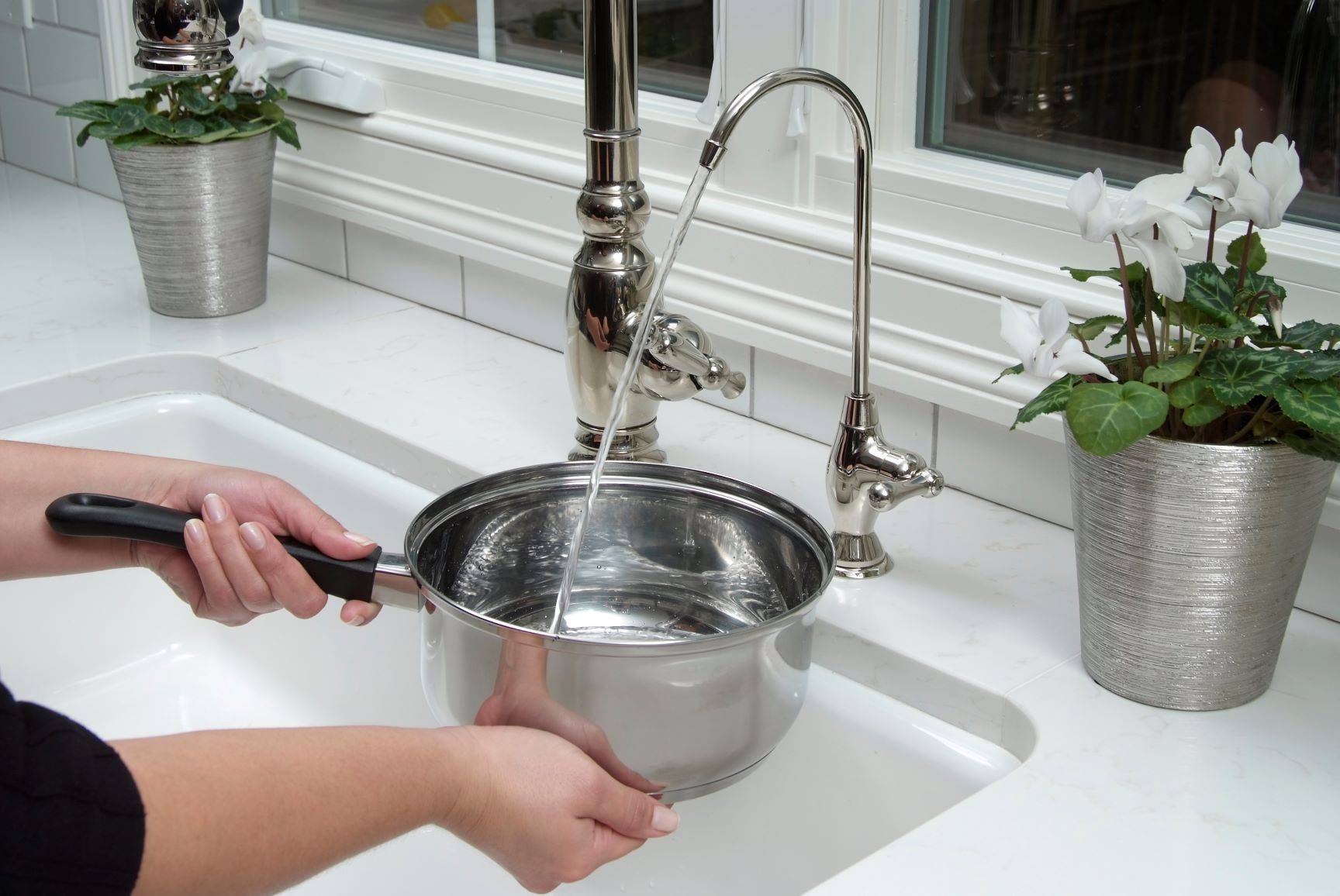 woman filling pot of water