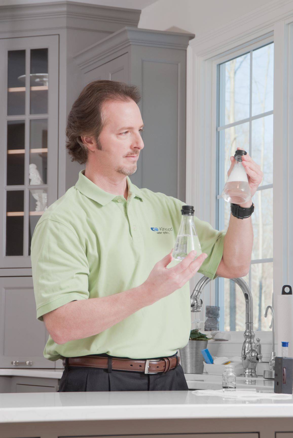 Kinetico Sales Professional Testing Water Samples in Kitchen HR