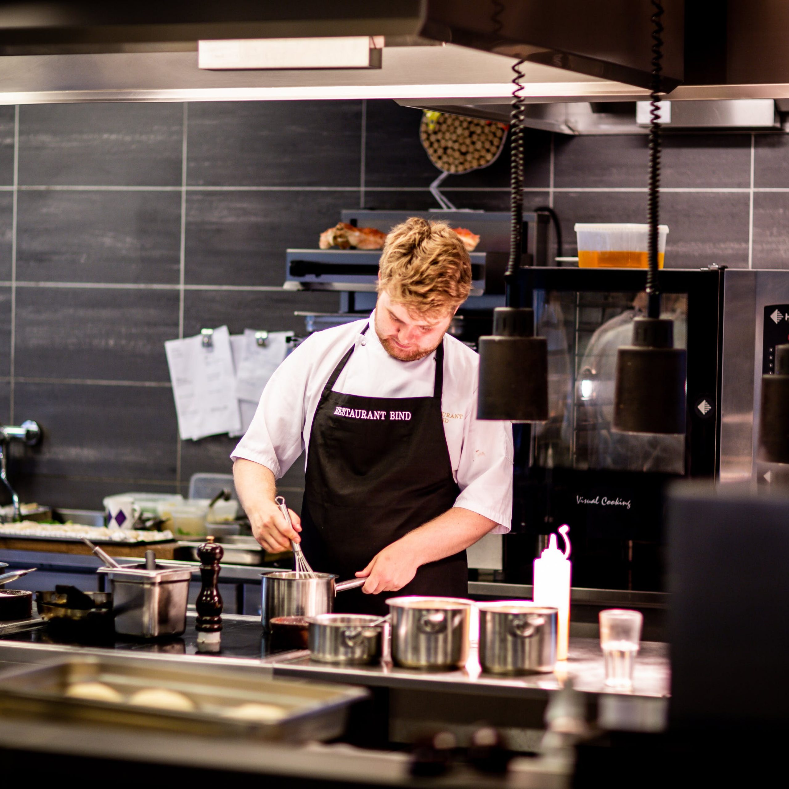 Man cooking in restaurant. Food service industry