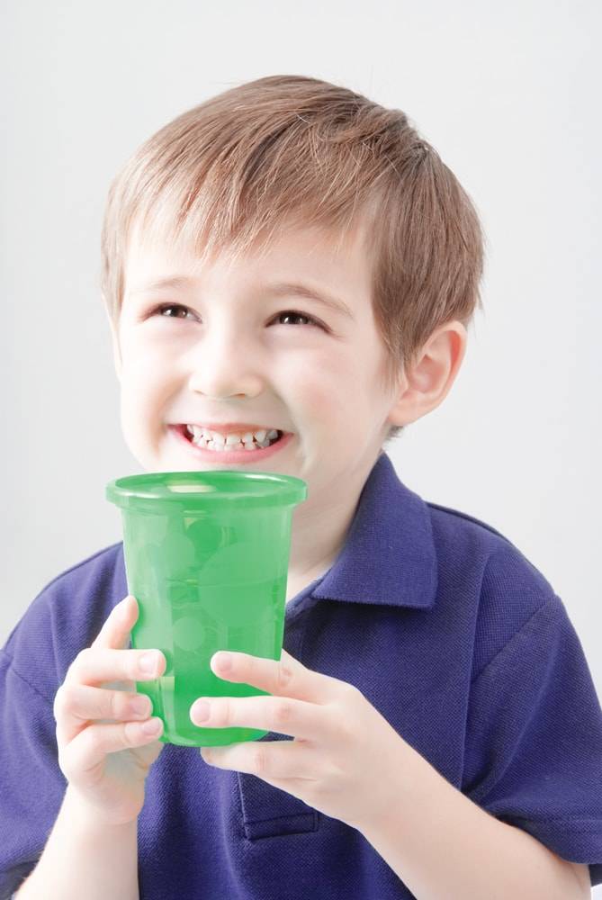 Boy Holding Green Cup of Drinking Water