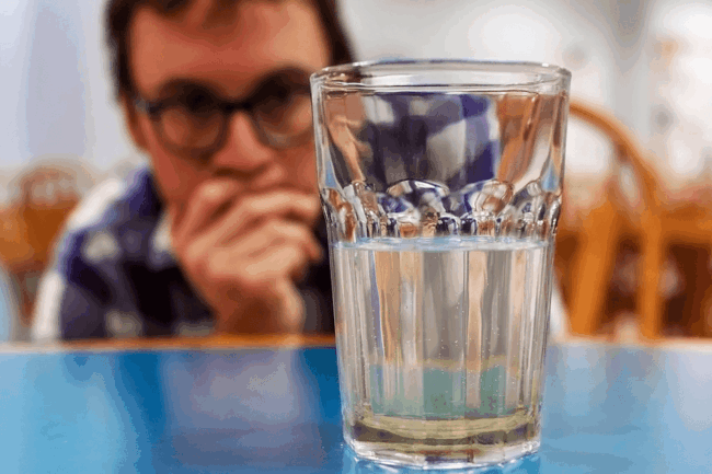 Man looking at water sediments Man looking at water sediments