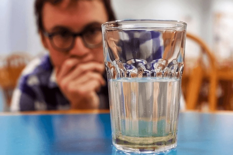 Man looking at water sediments