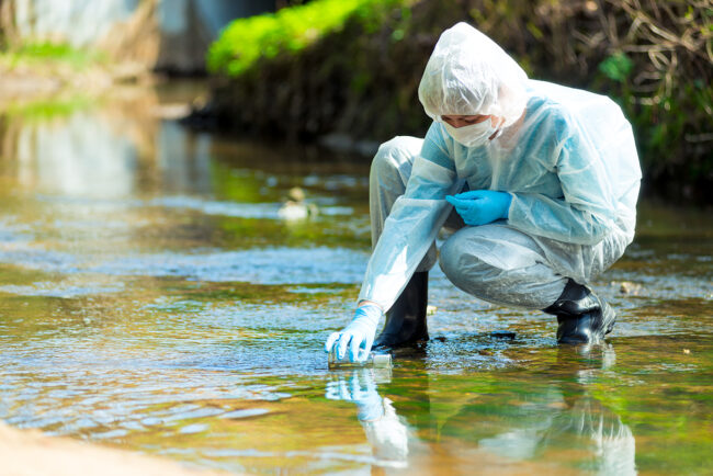 Scientist,Researcher,In,Protective,Suit,Takes,Water,For,Analysis,From Scientist,Researcher,In,Protective,Suit,Takes,Water,For,Analysis,From