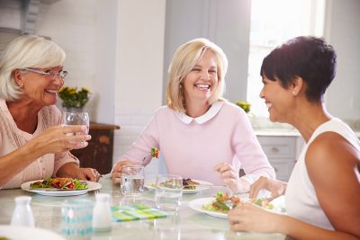 Group,Of,Mature,Female,Friends,Enjoying,Meal,At,Home